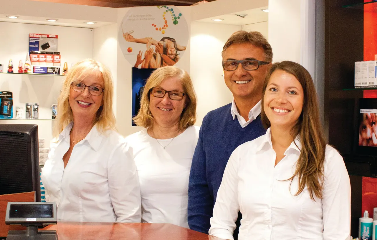 The staff of Alf Opheim Optikk behind the counter